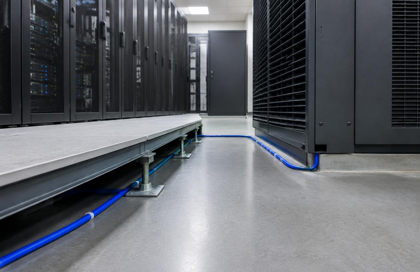 Water-leak sensing rope routed beside data-center cooling equipment and server racks